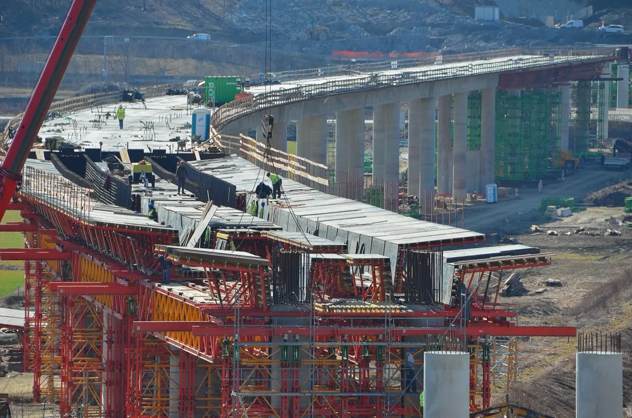 Kestrel Viaduct: concrete piers and a half-built deck, with red steel formwork in the front